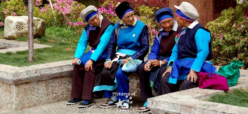4 old women on a bank
